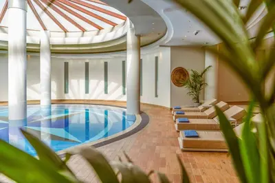 a swimming pool in a building with a domed ceiling at Caldera Beach in Plataniás