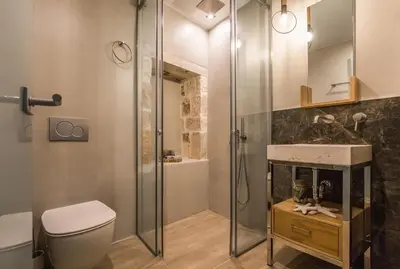 a bathroom with a shower and a toilet and a sink at The Peach House in Chania Town