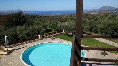 a swimming pool with a view of the ocean at Stratos Villas in Melidhónion