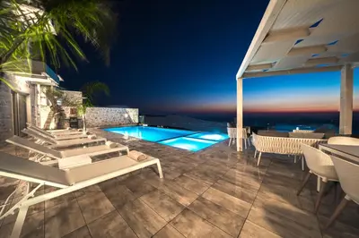 a villa with a swimming pool at night at Nafsika Xenia Villa in Plátanos
