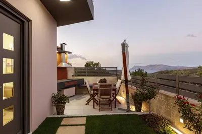 a patio with a table and chairs on a balcony at Villa Chryssi in Kissamos
