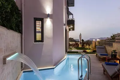 a swimming pool with a water fountain at Villa Chryssi in Kissamos
