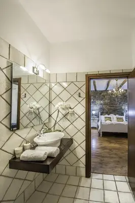 a bathroom with a sink and a mirror at Villa Kalithea in Pemónia