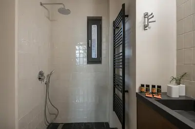 a bathroom with a shower and a sink at Velanis Ηouse, style into nature - secluded in Kissamos