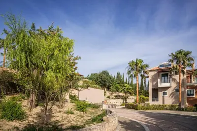 a house on a street with palm trees at Athina Luxury Villas in Xamoudhokhórion