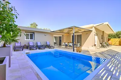 a swimming pool in the backyard of a house at Villa Calliope in Chania Town
