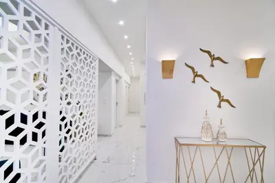 a white hallway with a console table and a white wall at Villa Calliope in Chania Town