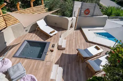 an overhead view of a deck with a pool and chairs at Verekinthos Villas - Pool, Hot Tub, BBQ, Kids Playground, Stunning Mountain Views in Gerolakkos