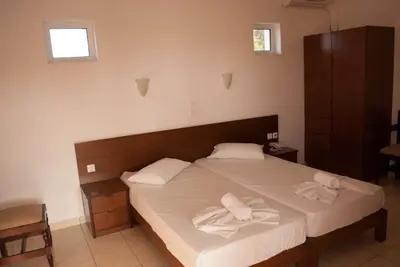 a bedroom with a bed with two towels on it at Thodorou Village in Agia Marina Nea Kydonias