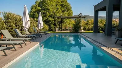 a swimming pool with lounge chairs and umbrellas at Villa Vega I 