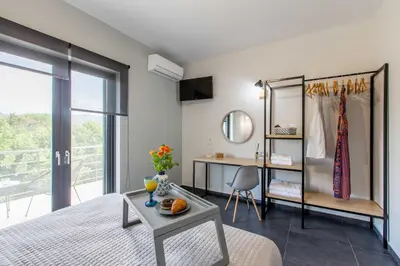 a bedroom with a bed and a table and a desk at Villa Vega I 