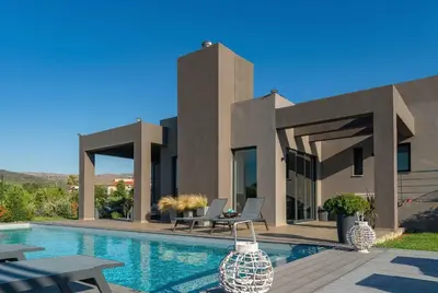 a house with a swimming pool in front of it at Villa Vega I 