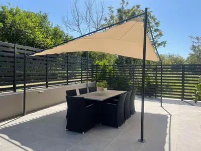 a table and chairs under an umbrella on a patio at Villa Vega I 