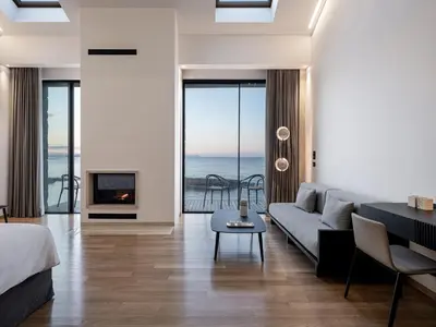 a living room with a couch and a fireplace at The Tanneries Hotel & Spa - a Member of Design Hotels in Chania Town