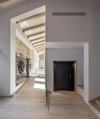 a hallway with white walls and a black door at The Tanneries Hotel & Spa - a Member of Design Hotels in Chania Town