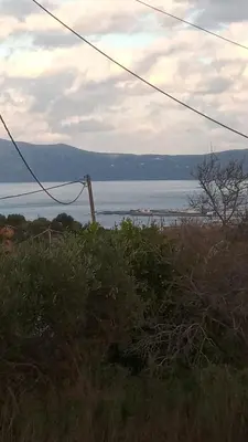 a view of a body of water from a field at TRADITIONAL HOUSE MARIA in Azoyirás