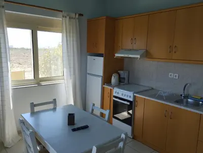 a kitchen with a table and a sink and a stove at Argilos Apartments in Frangokastello
