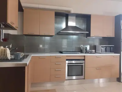 a kitchen with wooden cabinets and a stove top oven at House escape in Chania Town