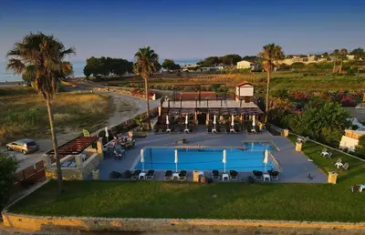 an aerial view of a resort with a pool and palm trees at Odos Oneiron Tavronitis Bay in Tavronitis