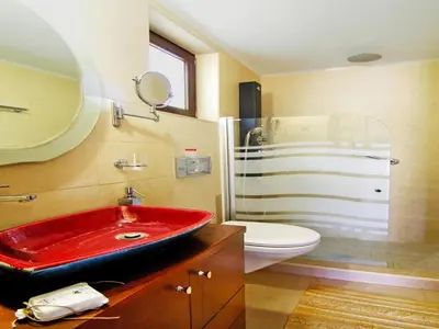 a bathroom with a red sink and a shower at Holiday home with pool in Kalamítsion Alexándrou