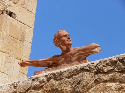 a statue of a man on top of a building at ARIALKiS - ΑΡΙΑΛΚίΣ in Plataniás