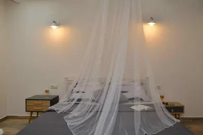 a bedroom with a bed with a mosquito net at Villa Christini a luxury villa with amazing views in Tzitzifés