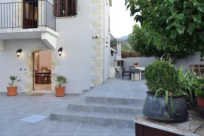 a courtyard with stairs and plants in a house at Villa Christini a luxury villa with amazing views in Tzitzifés