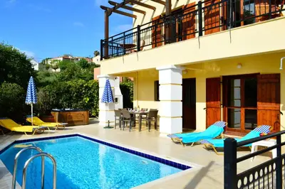 a villa with a swimming pool and a patio at Villa Spilia Homeleader in Spiliá
