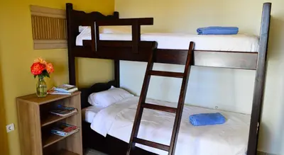 two bunk beds in a room with a vase of flowers at Villa Ravdoucha Homeleader in Ravdhoúkha