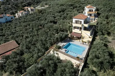 an aerial view of a house with a swimming pool at Villa Hibiscus in Spiliá