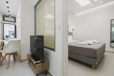 a bedroom with a bed and a tv in a room at Peris 1 - Central Apt near Old Town with Parking in Chania Town