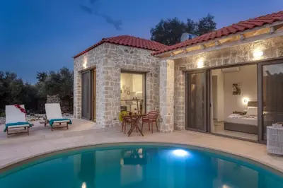 a patio with a swimming pool and a house at Canna Villa in Vamos