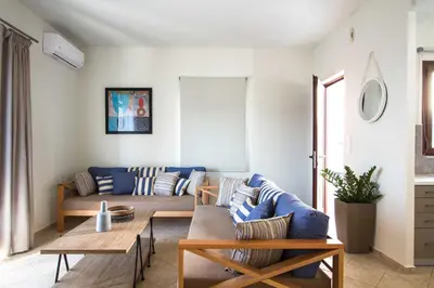 a living room with a couch and a table at Mike's apartment I Luxury above the sea in Kissamos
