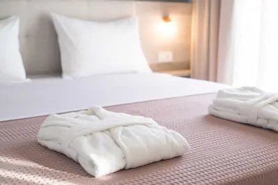 two towels on a bed in a hotel room at Mike's apartment I Luxury above the sea in Kissamos