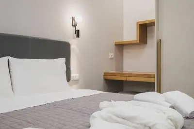 a bedroom with a white bed with white pillows at Peris 2 - Central Apt near Old Town - AC, Washer in Chania Town