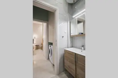 a bathroom with a sink and a washing machine at Peris 2 - Central Apt near Old Town - AC, Washer in Chania Town