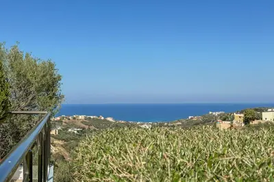 a view of the ocean from the balcony of a house at Pano Stalos Villas in Stalos