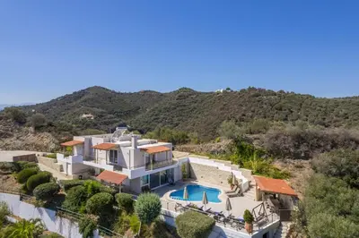 an aerial view of a house with a swimming pool at Pano Stalos Villas in Stalos