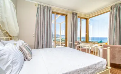 a bedroom with a bed and a view of the ocean at Luxuryvillaschania Kore-Falasarna beach in Falasarna