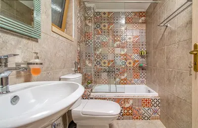 a bathroom with a sink and a toilet and a tub at Luxuryvillaschania Kore-Falasarna beach in Falasarna