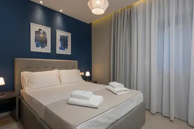 a bedroom with a bed with towels on it at MIRMA CITY Old Town in Chania Town