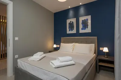 a bedroom with a bed with two towels on it at MIRMA CITY Old Town in Chania Town
