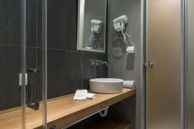 a bathroom with a sink and a shower at MIRMA CITY Old Town in Chania Town