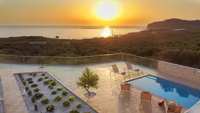 an aerial view of a swimming pool with the sunset at 2 steps Falasarna beach-Liakos- Homeleader in Falasarna