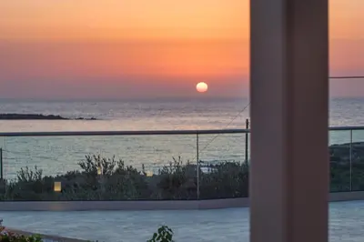 a sunset over the ocean from a house at 2 steps Falasarna beach-Liakos- Homeleader in Falasarna