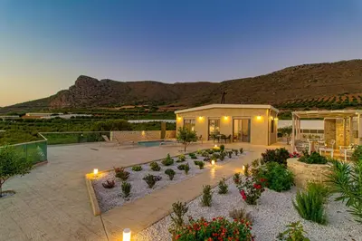 a garden with lights and flowers in front of a building at 2 steps Falasarna beach-Liakos- Homeleader in Falasarna
