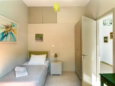 a bedroom with two beds and a mirror at Villa Anemos by Estia in Kalathas
