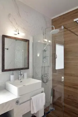a bathroom with a white sink and a shower at Villa Anemos by Estia in Kalathas
