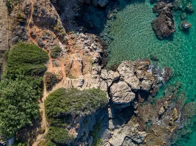an aerial view of the rocks and the ocean at Villa Anemos by Estia in Kalathas