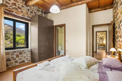 a bedroom with two beds and a large window at Kambos Horizon & Paradise Villas in Kissamos